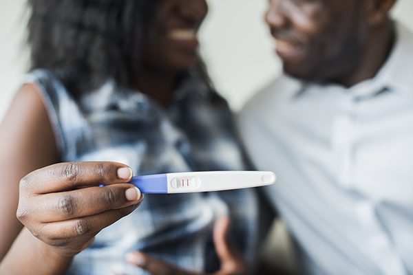 Black couple with a positive pregnancy test result